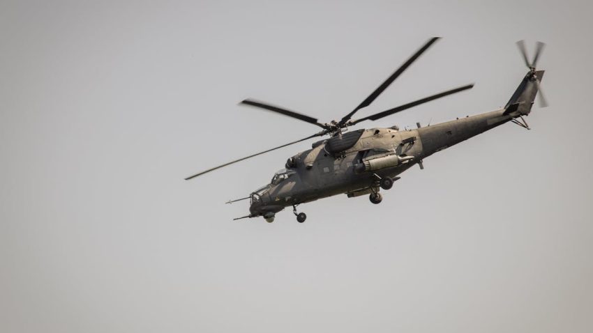 A military helicopter flying at a low angle against a clear sky in Belgrade, Serbia.